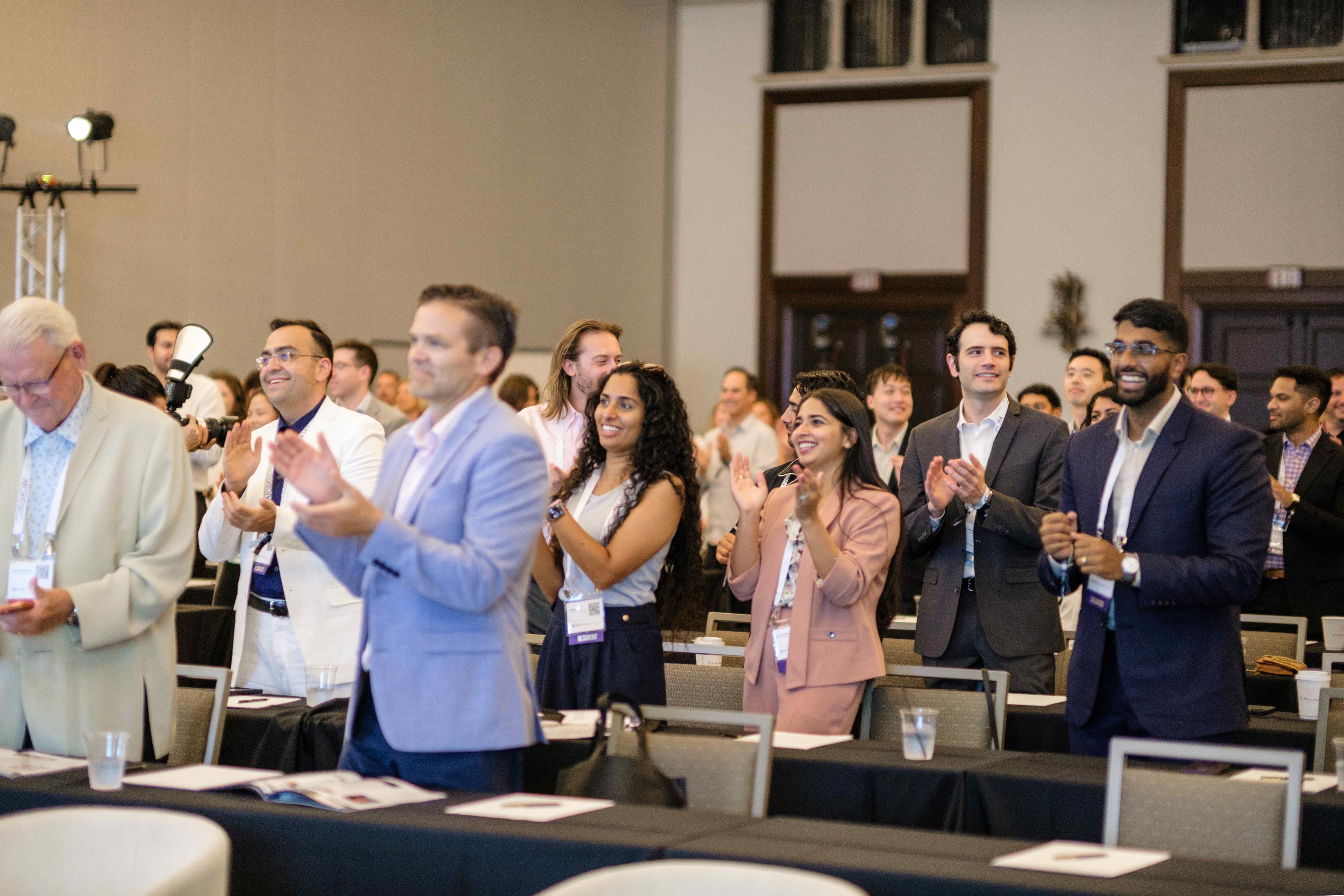 Residents standing and applauding during a main-stage session