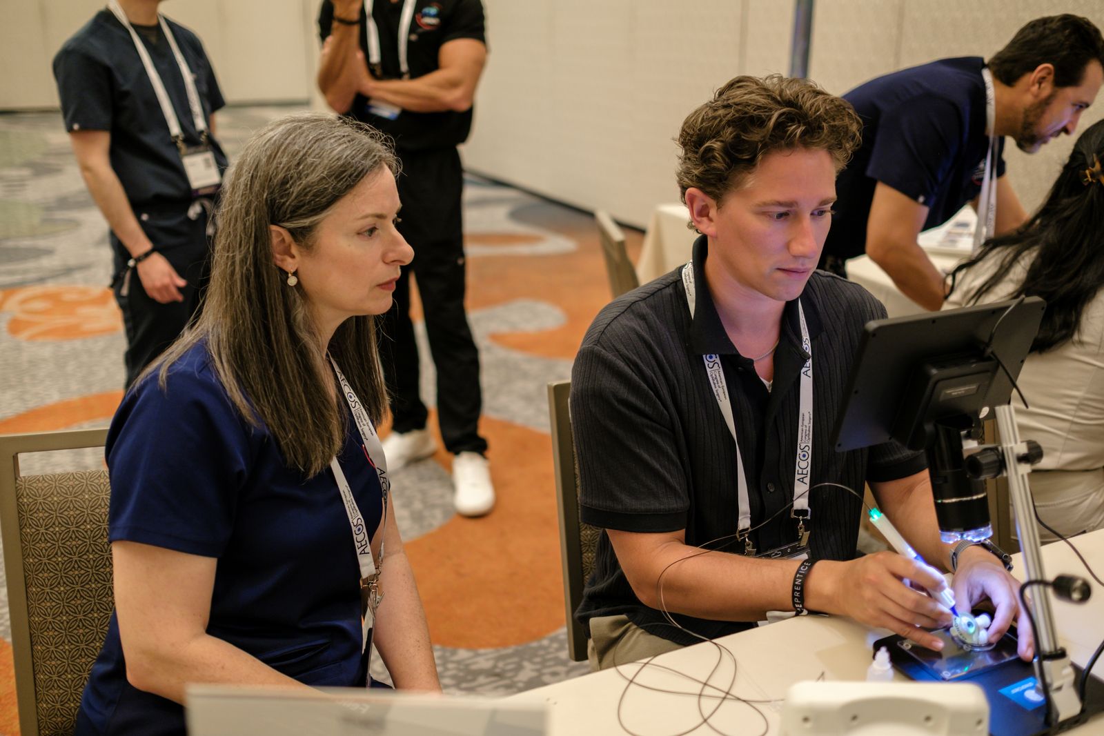 Two residents working side by side at digital microscope teaching stations