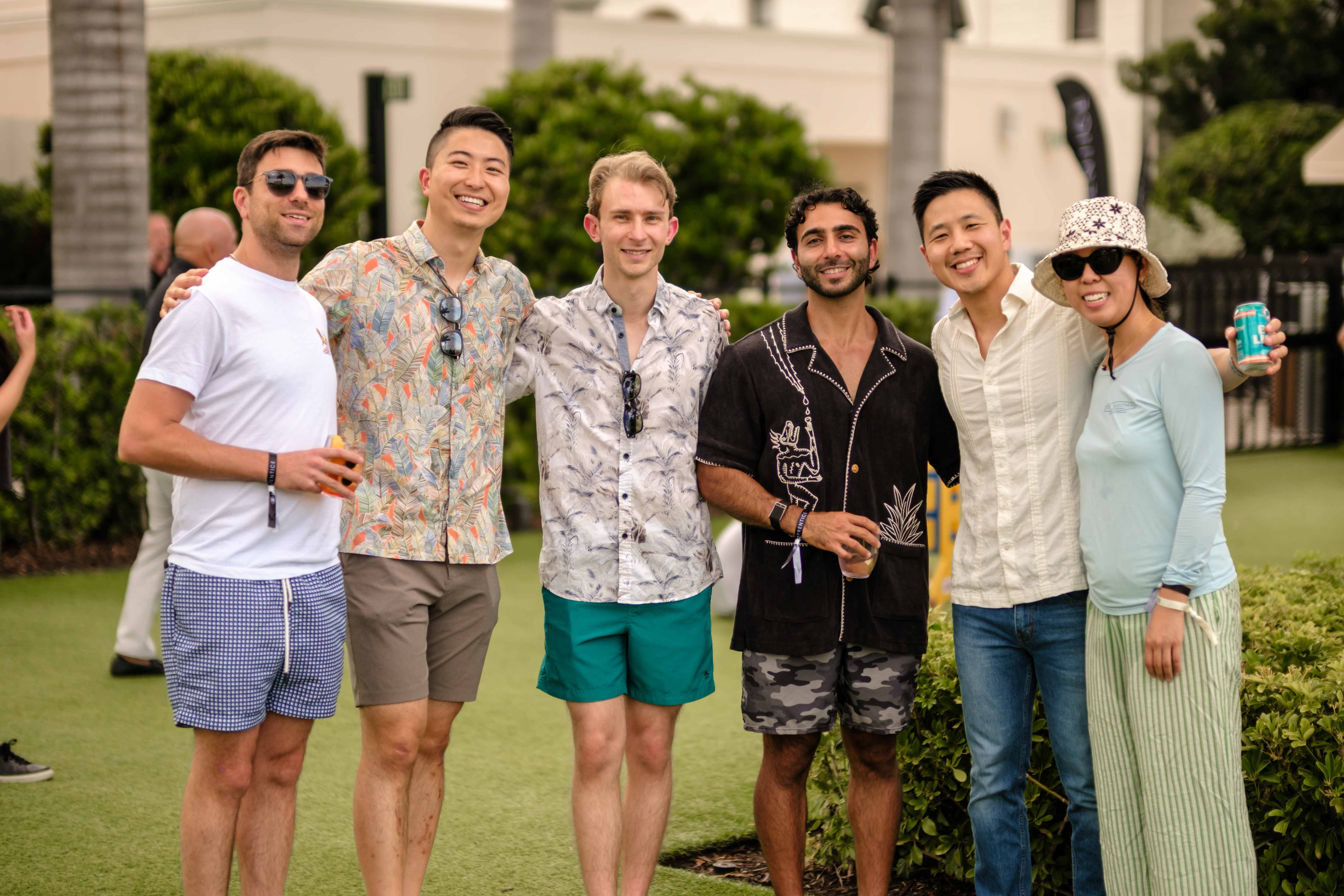 Residents posing together on the lawn at an outdoor Eyeprentice reception