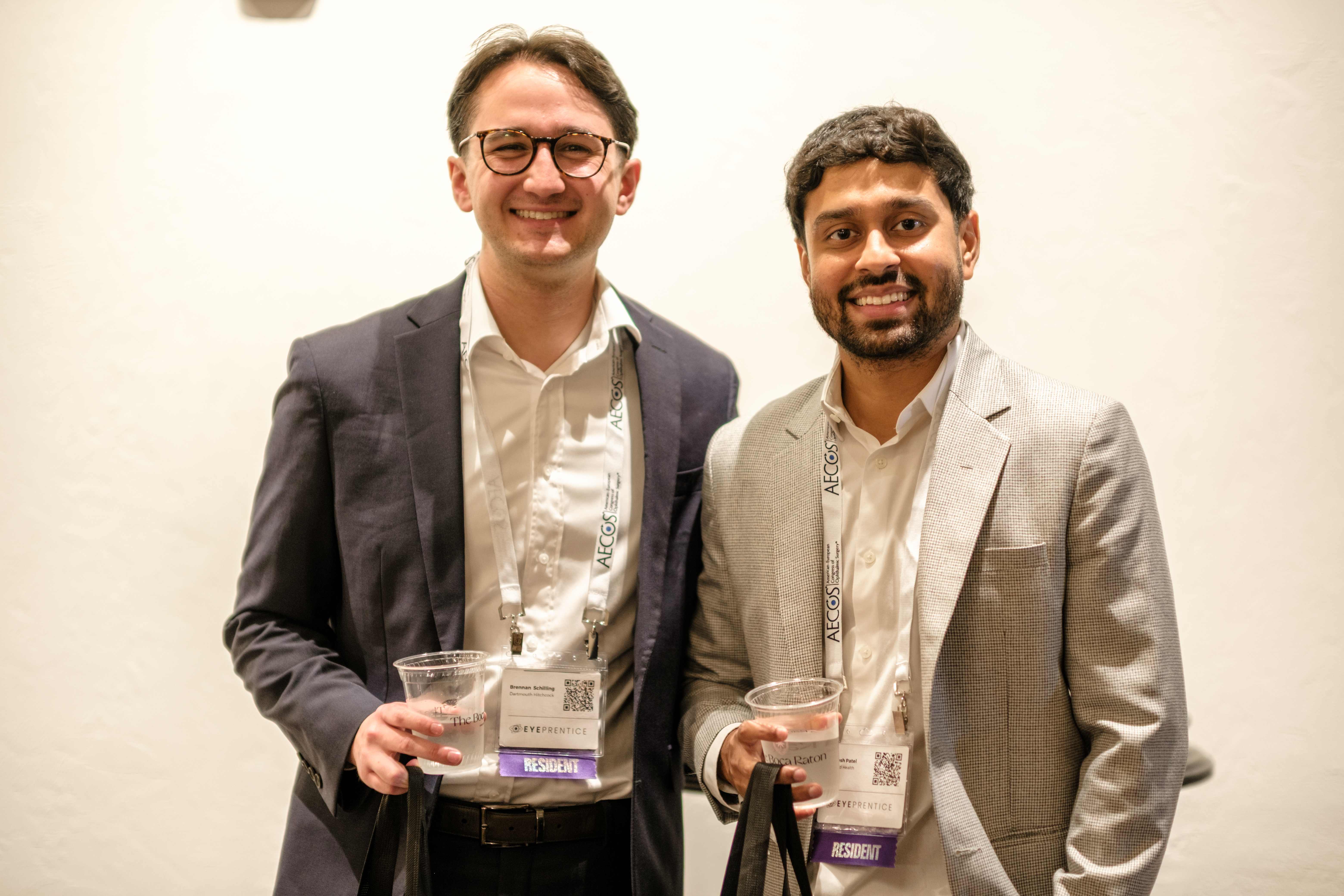 Two residents posing with drinks at the Showcase reception